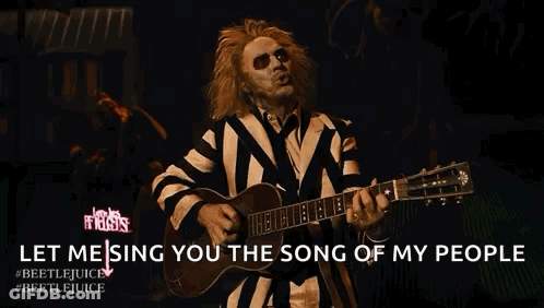 Man In Striped Suit Playing Guitar Singing Song Of My People GIF
