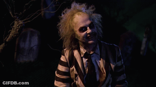 Man In Striped Suit Saying How You Doing In Cemetery GIF