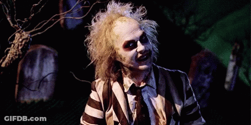 Man In Striped Suit Smiling Holding Knife GIF