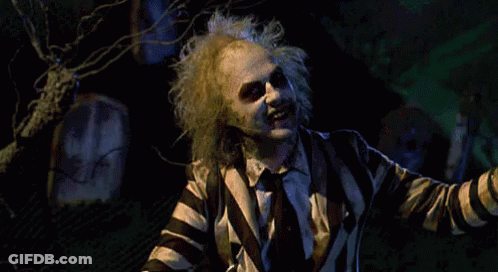Man In Striped Suit Standing In Cemetery GIF