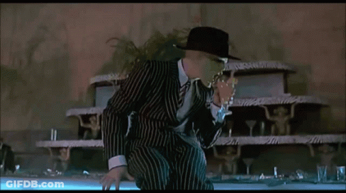 Man In Striped Suit Standing In Front Of Cake GIF