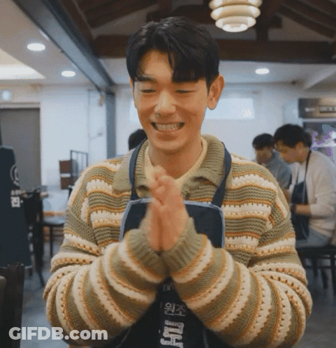 Man In Striped Sweater And Apron With Foreign Language GIF