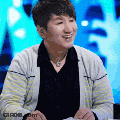 Man In Striped Sweater And Black Shirt Smiling GIF