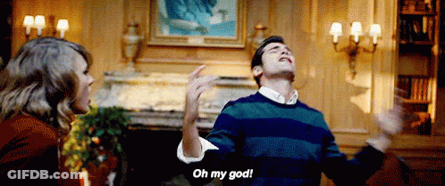 Man In Striped Sweater Saying Oh My God To Woman GIF