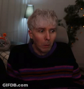 Man In Striped Sweater Sitting In Chair GIF
