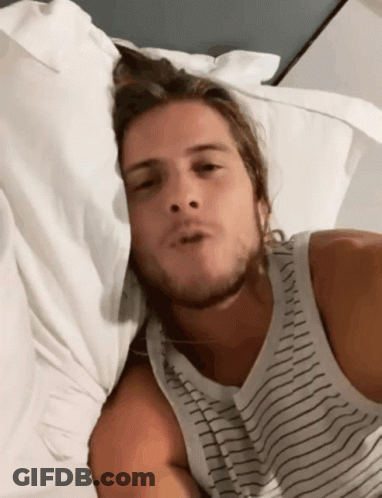 Man In Striped Tank Top Laying In Bed GIF