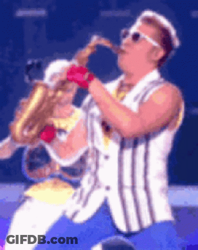 Man In Striped Vest Playing Saxophone On Stage GIF