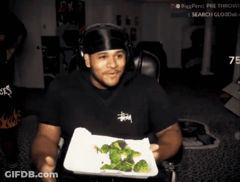 Man In Stussy Shirt Holding Tray Of Broccoli GIF