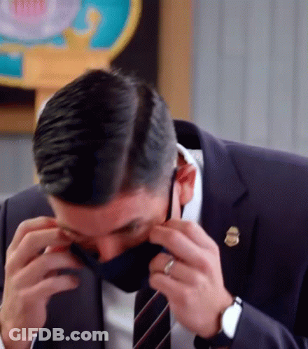 Man In Suit Adjusting Face Mask GIF