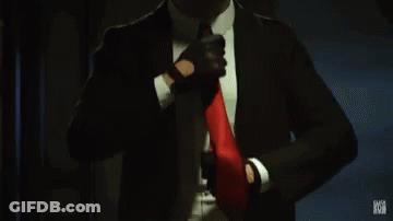 Man In Suit Adjusting Red Tie GIF