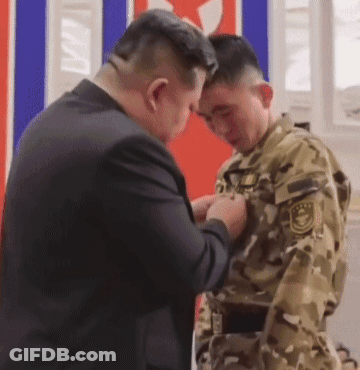 Man In Suit Adjusting Soldier's Uniform GIF