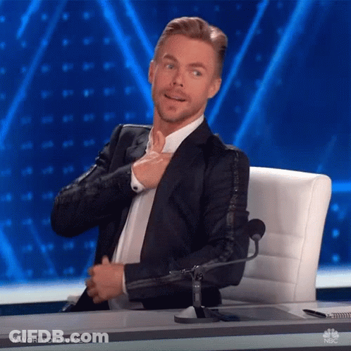 Man In Suit Adjusting Tie At Microphone GIF