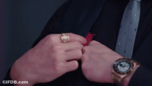 Man In Suit Adjusting Tie With Watch GIF