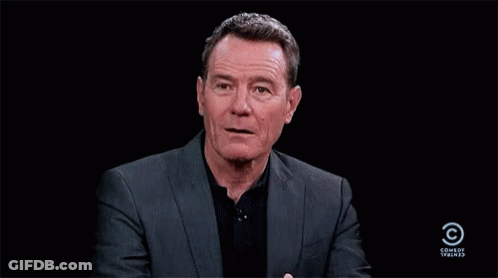 Man In Suit And Black Shirt In Front Of Comedy Central GIF