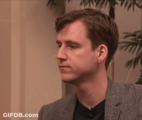 Man In Suit And Black Shirt Looking To Side GIF