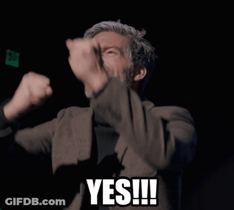 Man In Suit And Black Turtleneck Giving Yes Sign GIF