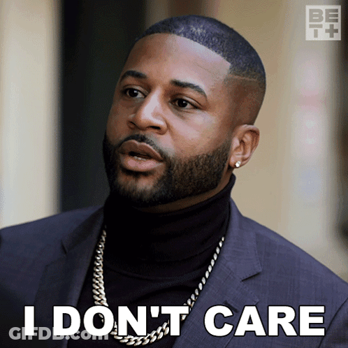 Man In Suit And Black Turtleneck Saying I Don't Care GIF