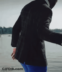 Man In Suit And Blue Pants Standing By Water GIF