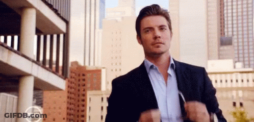 Man In Suit And Blue Shirt In City GIF