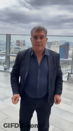 Man In Suit And Blue Shirt On Balcony GIF