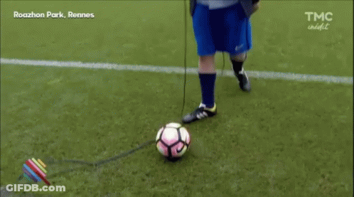 Man In Suit And Blue Shorts On Soccer Field GIF