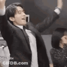 Man In Suit And Bow Tie Dancing Arms Up GIF