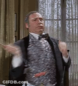 Man In Suit And Bow Tie Hands Up GIF