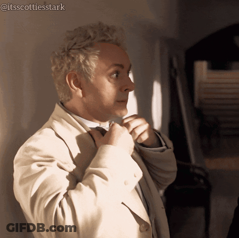 Man In Suit And Bow Tie In Front Of Ncuti Gatwa Sign GIF