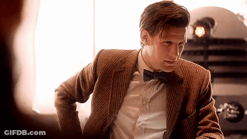 Man In Suit And Bow Tie Looking At Another Man GIF