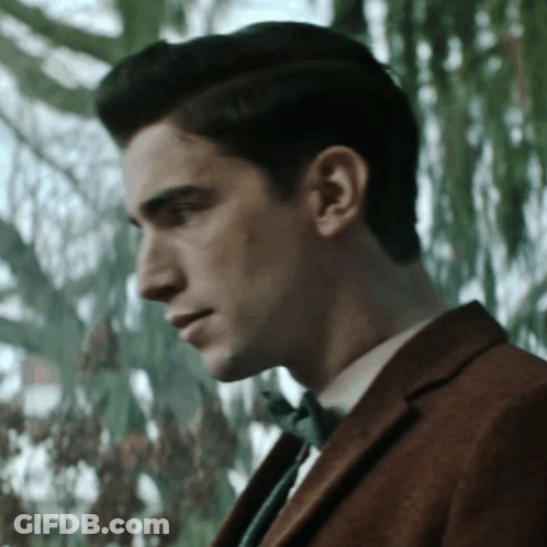 Man In Suit And Bow Tie Looking Down GIF