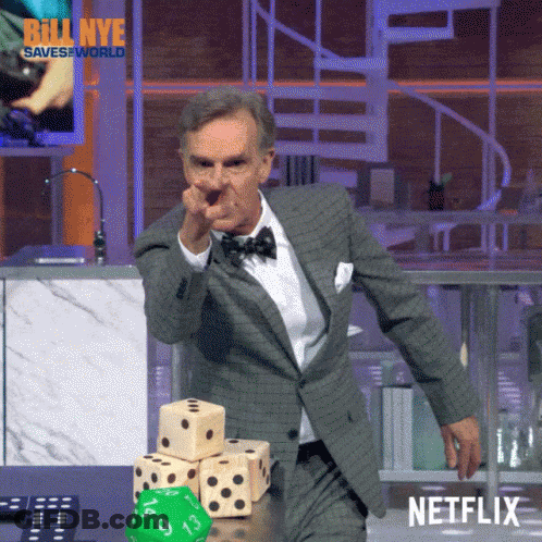 Man In Suit And Bow Tie Pointing At Dice Stack Netflix Logo GIF