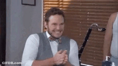 Man In Suit And Bow Tie Sitting By Window GIF