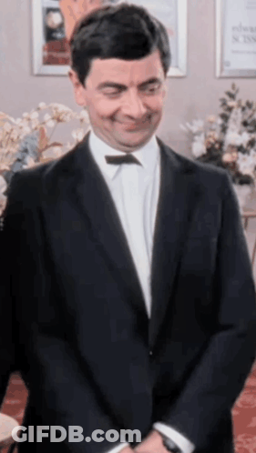 Man In Suit And Bow Tie Smiling GIF