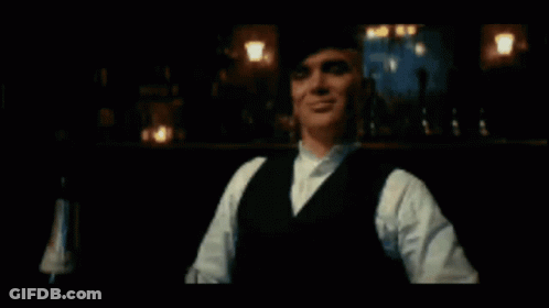 Man In Suit And Bow Tie Walking Down Street With Netflix Logo GIF