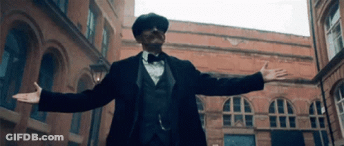 Man In Suit And Bow Tie With Arms Outstretched GIF