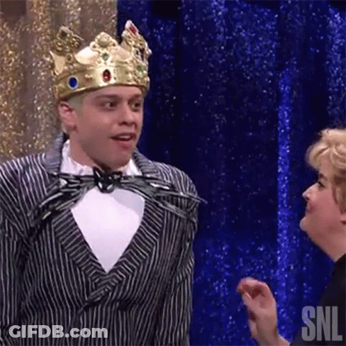 Man In Suit And Crown Next To Woman GIF
