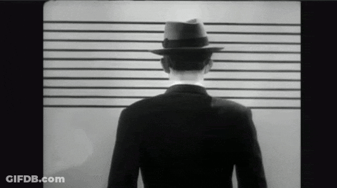 Man In Suit And Fedora In Police Lineup GIF