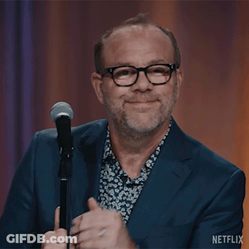 Man In Suit And Glasses At Microphone Netflix GIF
