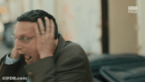 Man In Suit And Glasses Covering Head GIF
