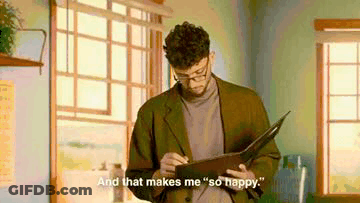 Man In Suit And Glasses Holding Book Says And That Makes Me So Happy GIF
