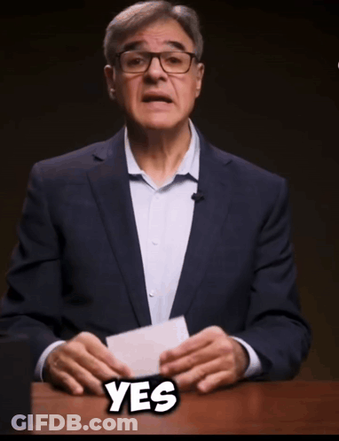 Man In Suit And Glasses Holding Paper Saying Yes GIF
