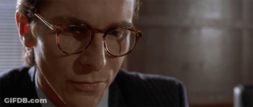 Man In Suit And Glasses Looking Down GIF