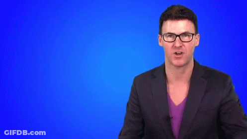 Man In Suit And Glasses Making Hand Gesture GIF