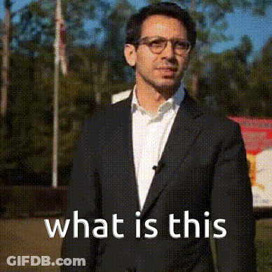 Man In Suit And Glasses Says What Is This GIF