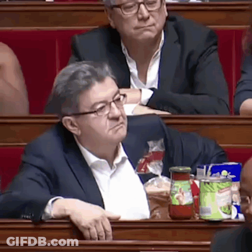 Man In Suit And Glasses Sitting In Classroom With Tomato Sauce GIF