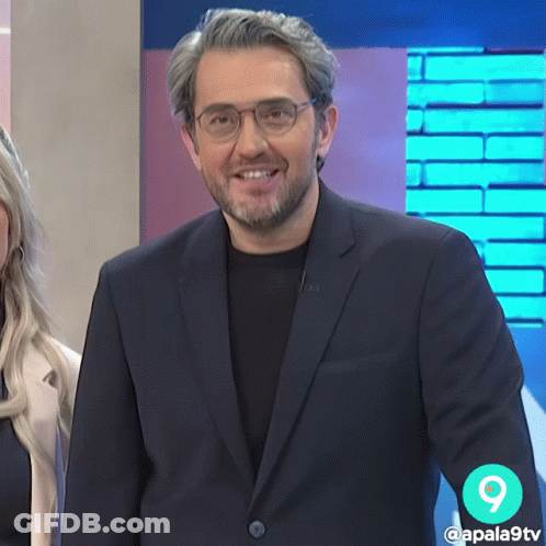 Man In Suit And Glasses Smiling With Number 9 GIF