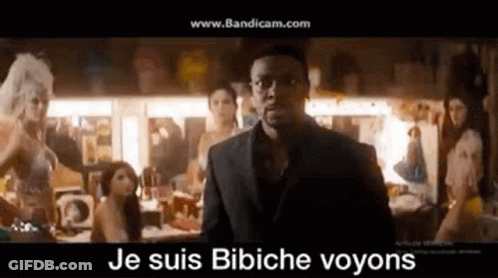 Man In Suit And Glasses Standing Before Women GIF