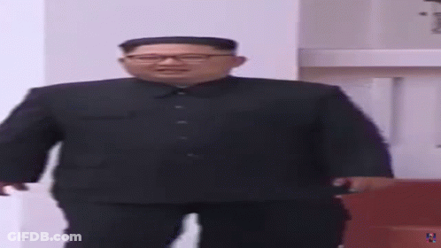 Man In Suit And Glasses Standing In Room GIF