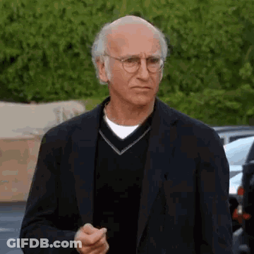 Man In Suit And Glasses Walking GIF