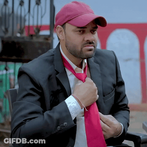 Man In Suit And Hat Adjusting Red Tie GIF